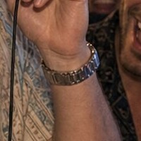 Close-up of the watch on the wrist in the DJ photo